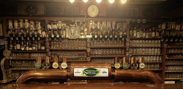 The well-stocked bar at Shamrock Irish Pub in Salzburg with a variety of draught beer taps including Guinness and Kilkenny, and an array of spirits and whiskey on the shelves